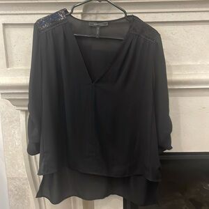 BCBG black v-neck sequins shoulder detail, high low blouse. Size medium.